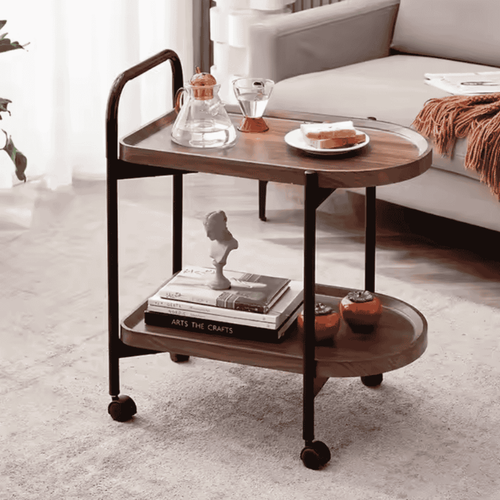 Wooden serving cart with decorative items in a living room setting