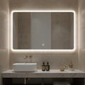 Bathroom vanity with illuminated mirror, sink, and toiletries.