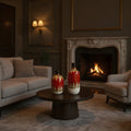 Cozy living room with a fireplace, sofa, armchair, and decorative vases on a table.