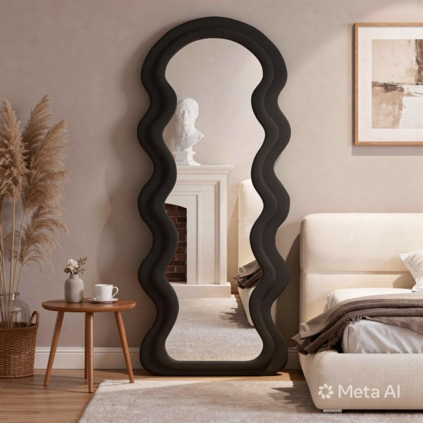 Wavy black mirror in a room with a bed, side table, and decor.