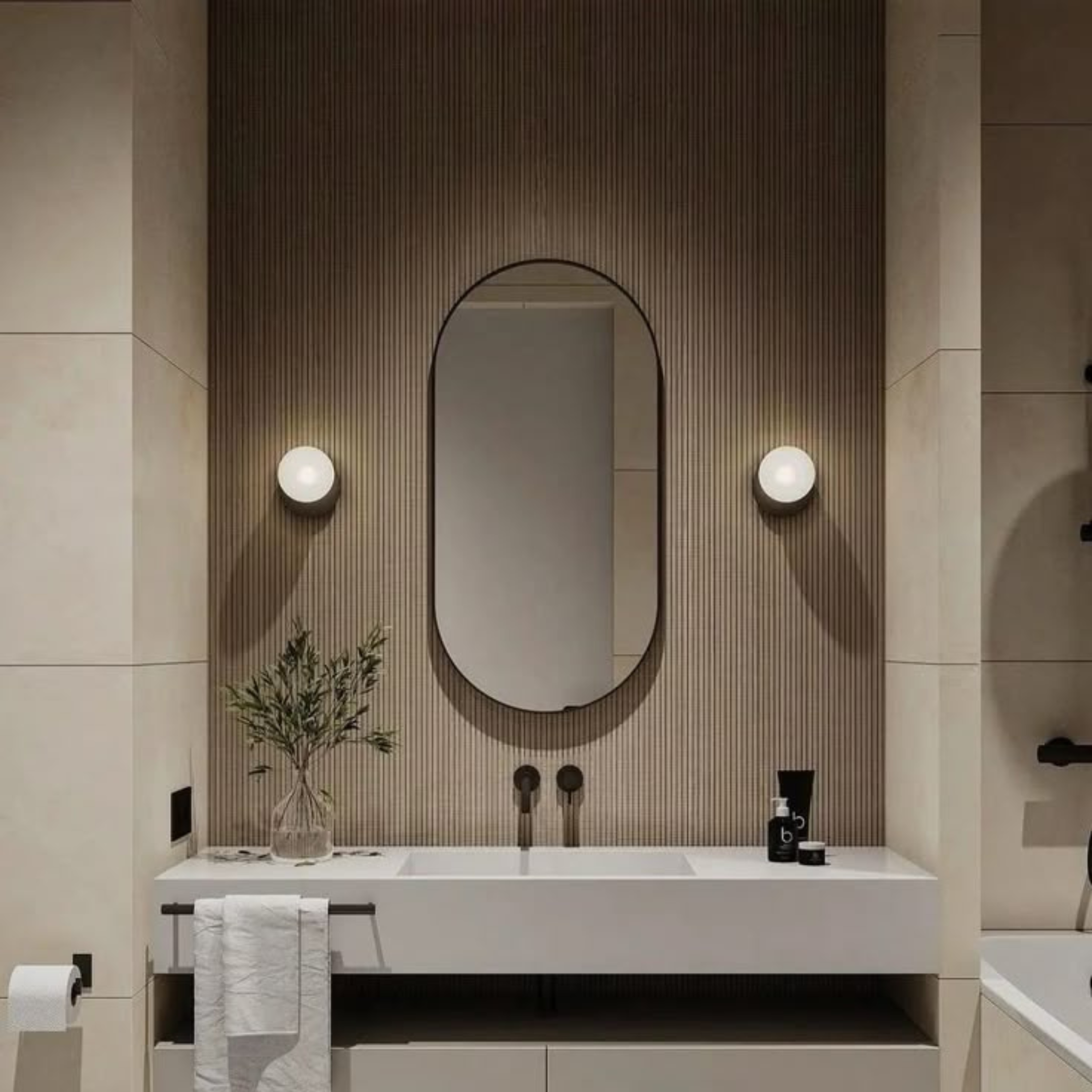 Modern bathroom vanity with oval mirror, light fixtures, and decorative elements.
