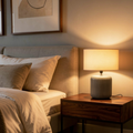 Cozy bedroom with a lamp on a nightstand next to a bed