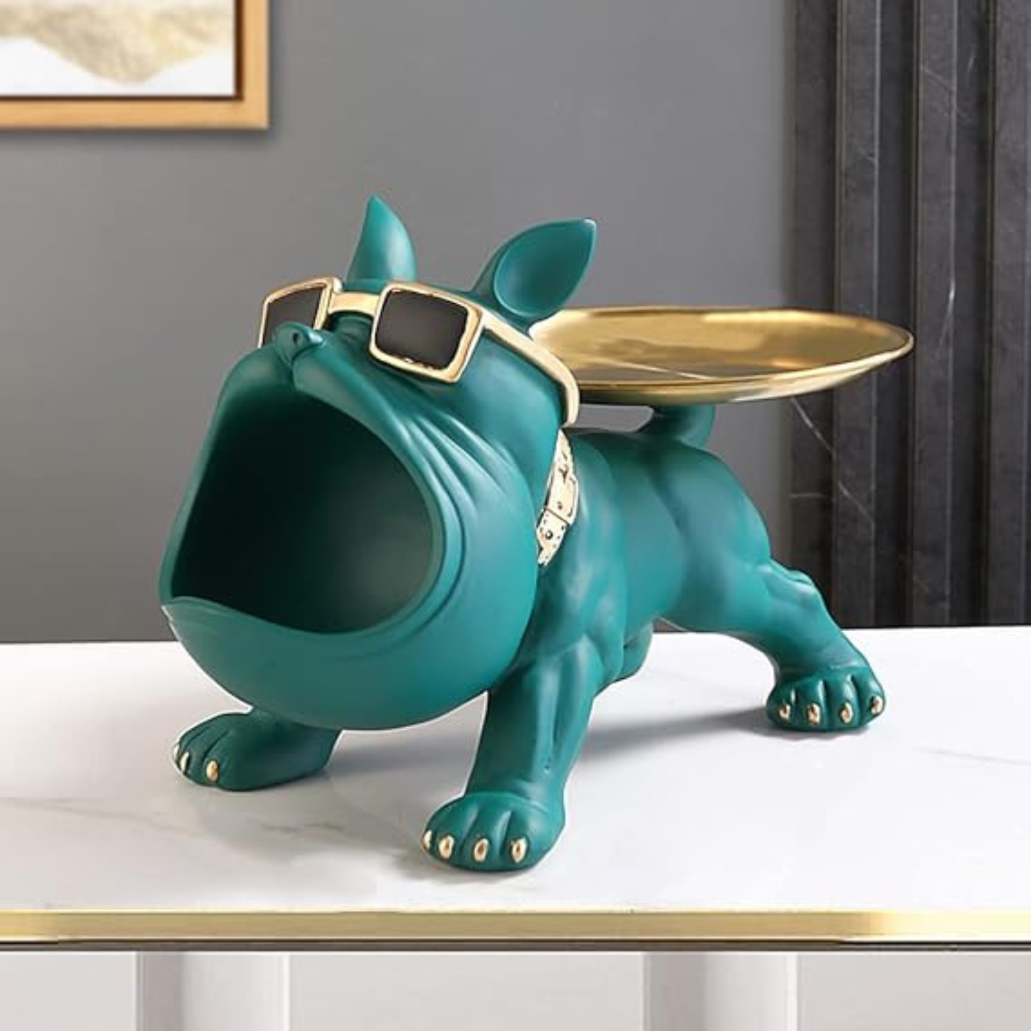 Teal dog-shaped object with a gold tray on a white surface